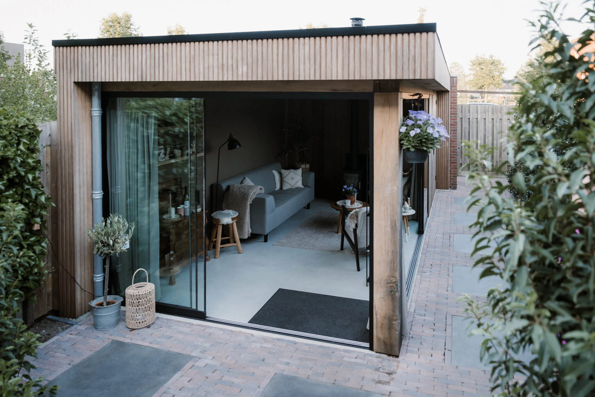 Tuinkamer op maat met glazen schuifwanden en houten constructi